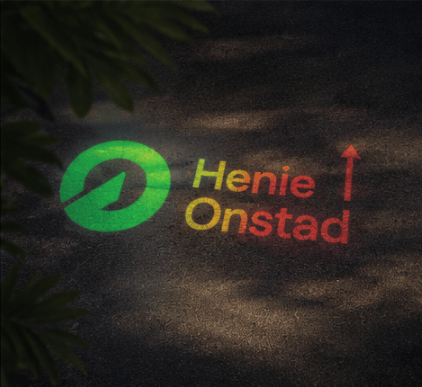 A projected logo and "Henie Onstad" text with an arrow on a dark, textured surface with shadows.