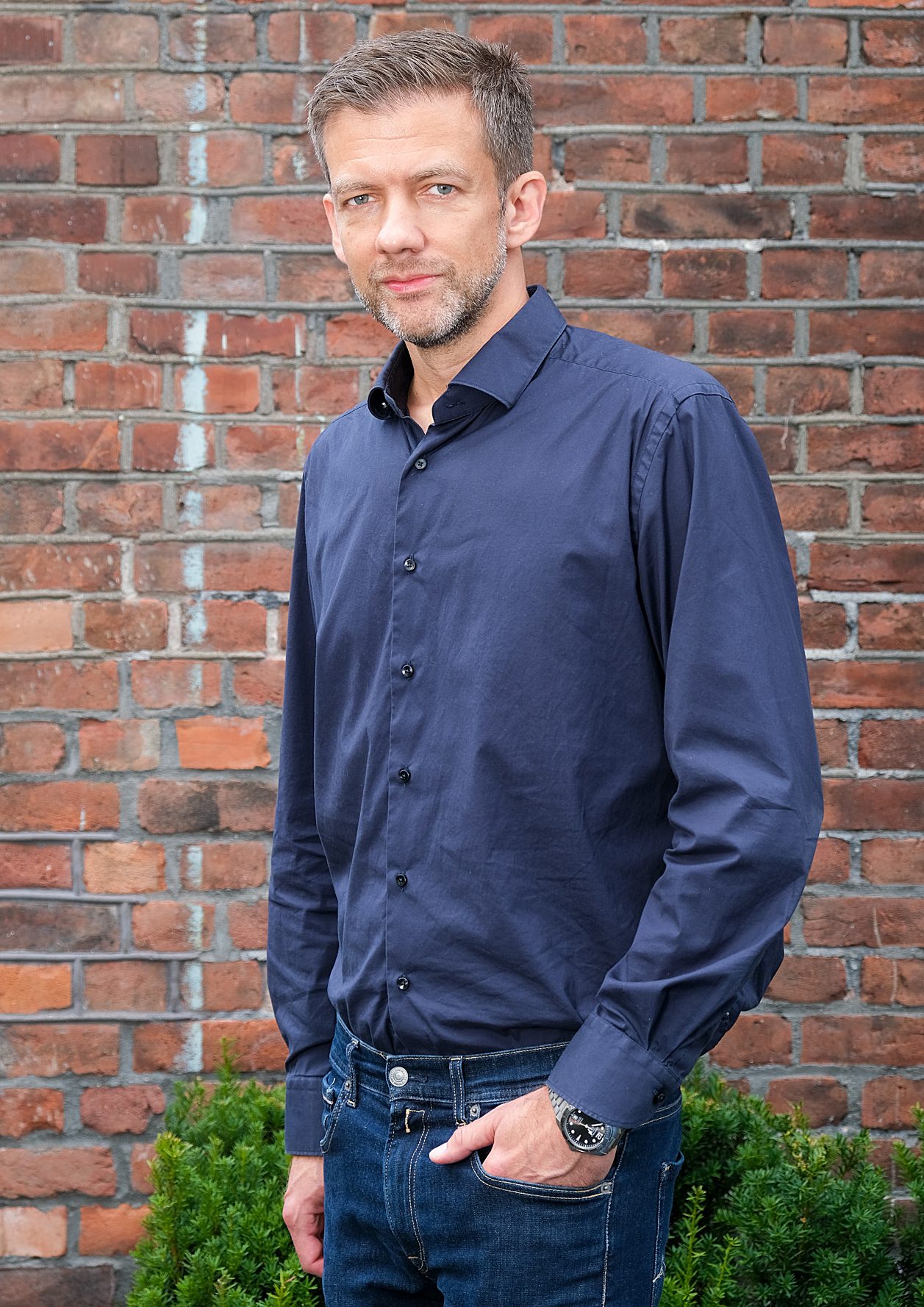 Dress shirt, Forehead, Plant, Beard, Sleeve, Standing, Brick, Grey, Brickwork
