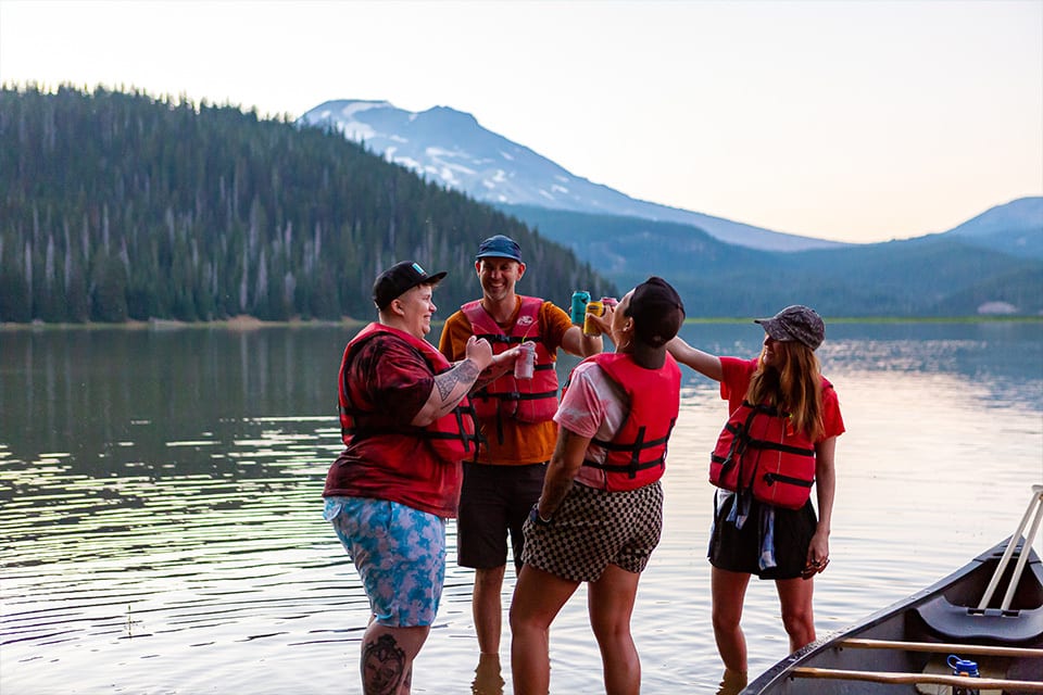 A group of people cheersing after a canoe ride