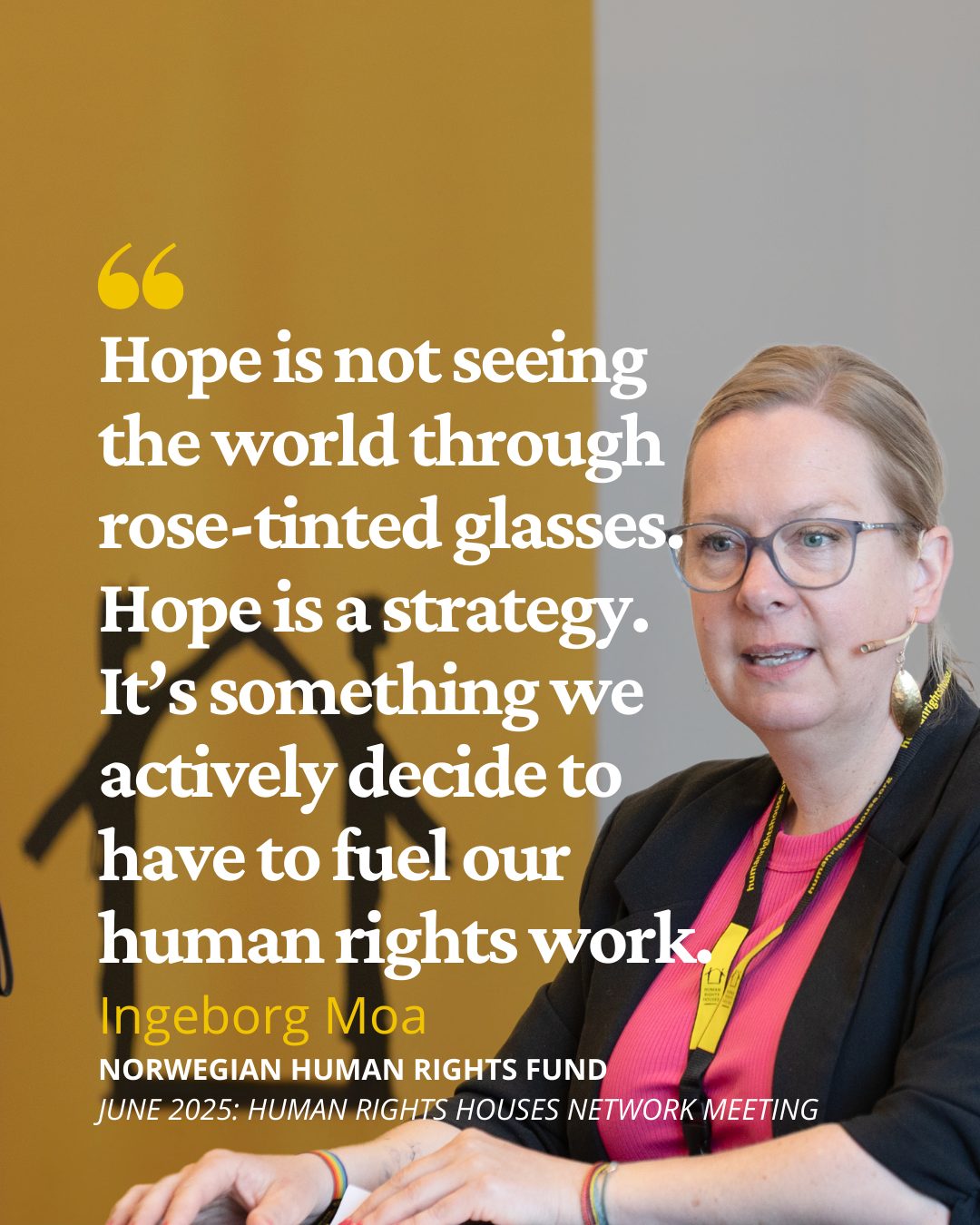 A woman with glasses speaks next to a quote about hope as a strategy for human rights work.