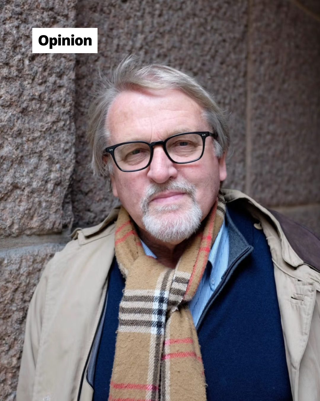 Man with glasses, beard, and plaid scarf against a stone wall. "Opinion" label in top left.