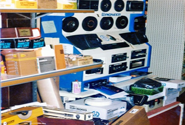 Cluttered display of Pioneer car audio equipment, including speakers and head units, in a store.