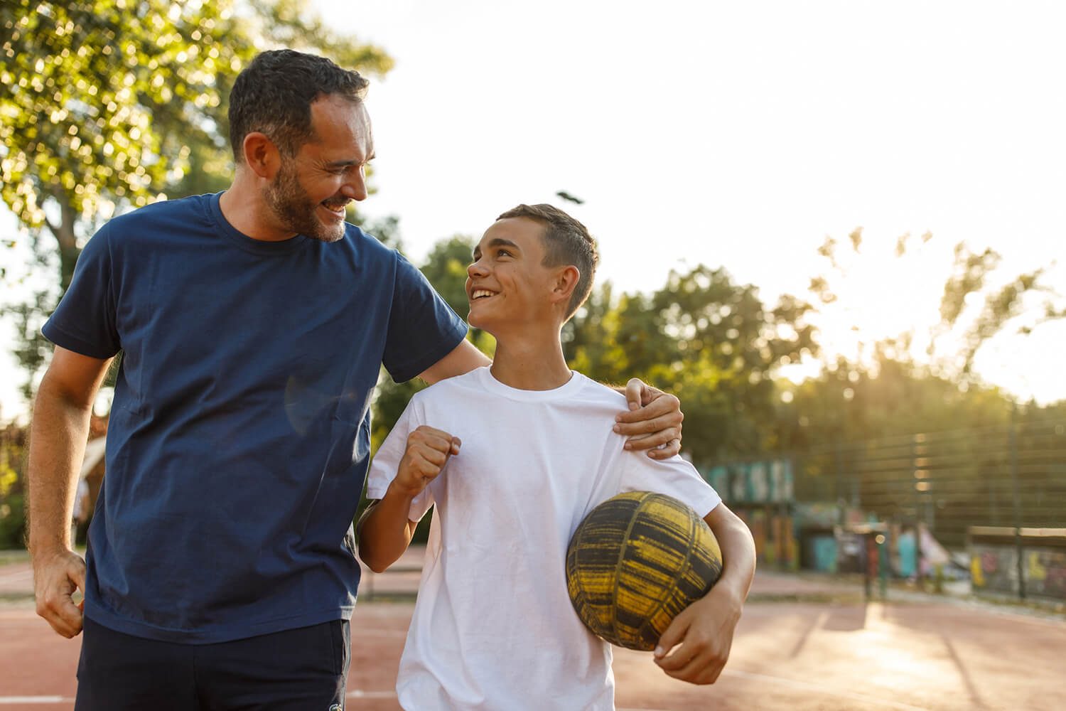 Sports equipment, Shorts, Smile, Sky, Football, Soccer, Ball, Gesture, Yellow, Tree