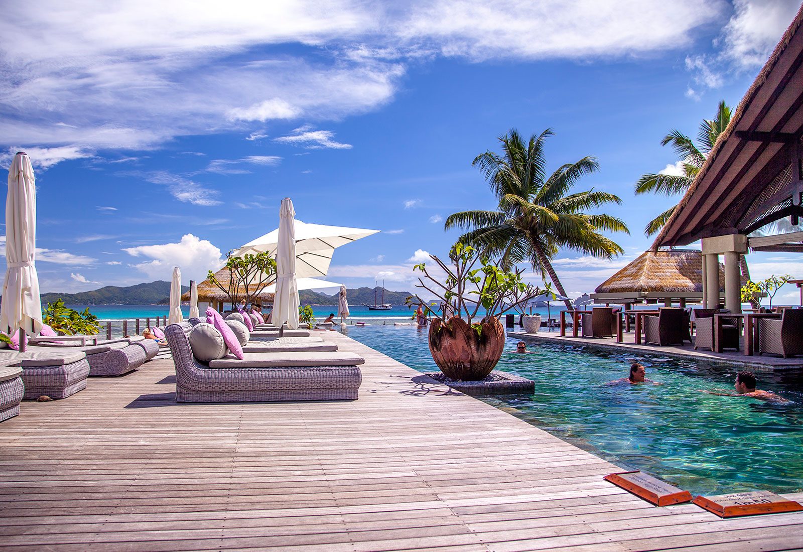 Body of water, Seaside resort, Swimming pool, Outdoor furniture, Cloud, Sky, Building, Plant, Leisure
