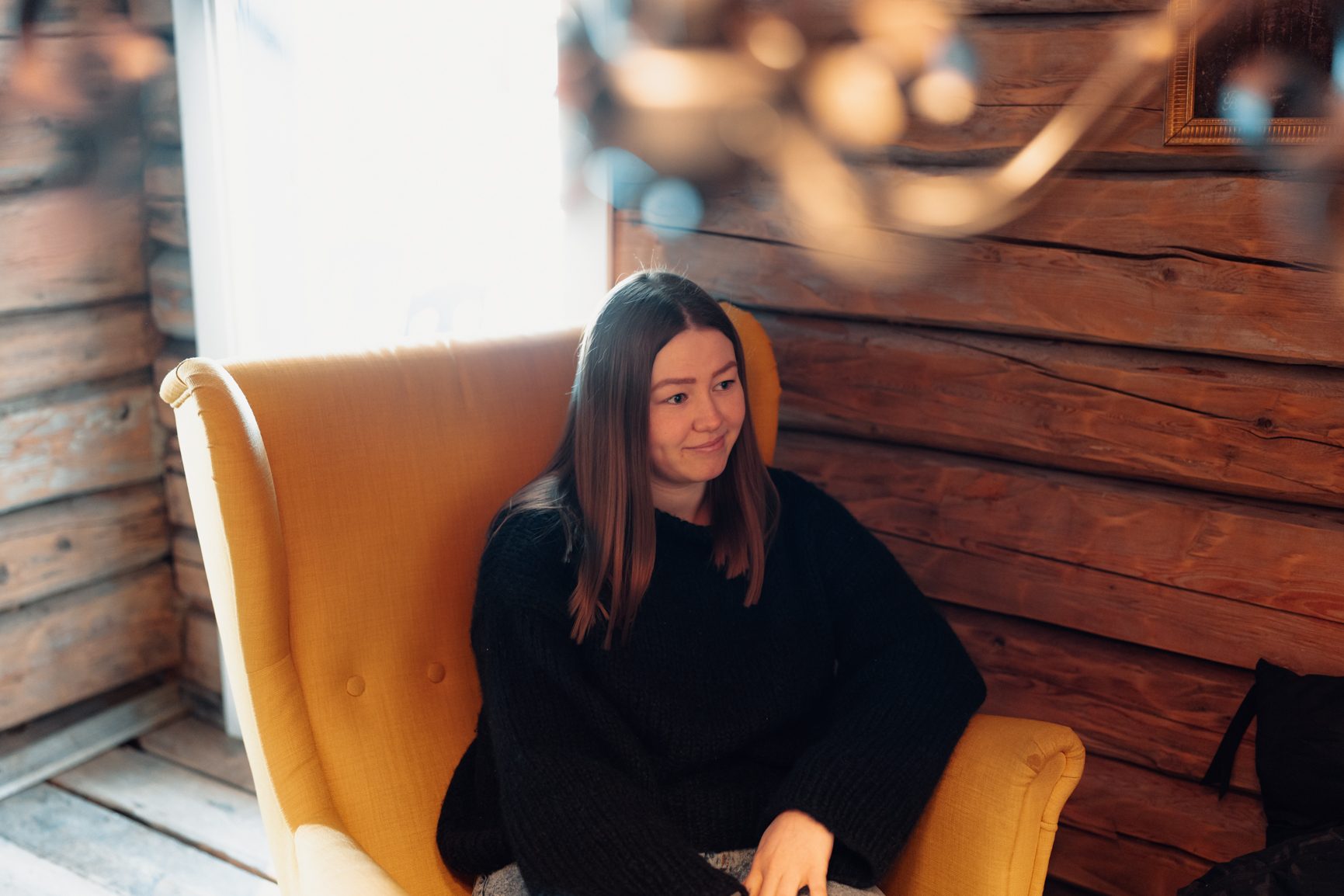 Interior design, Long hair, Furniture, Sitting, Smile, Comfort, Blond