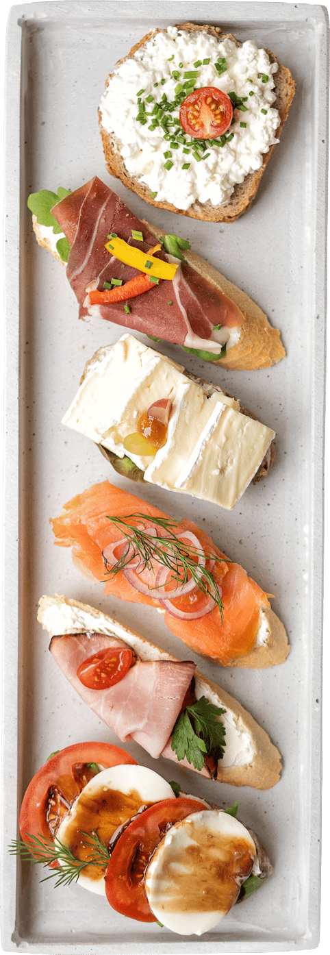 Variety of open-faced sandwiches/crostini: cottage cheese, prosciutto, brie, salmon, ham, tomato mozzarella.