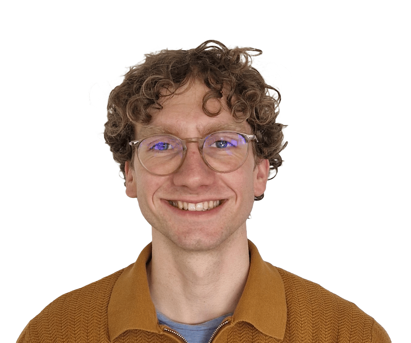 A smiling man with curly brown hair and glasses looks directly at the camera against a green background.
