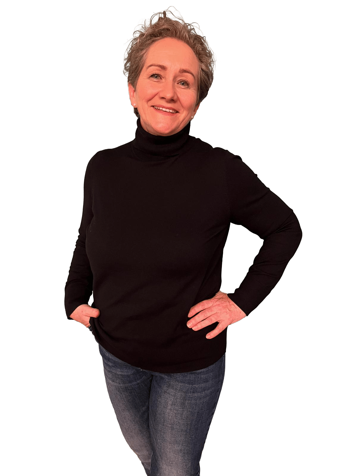 Smiling woman in black turtleneck and jeans, hands on hips.
