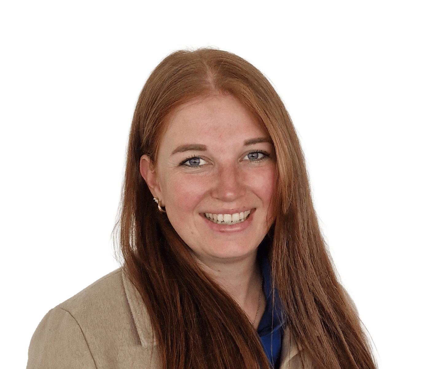 Headshot of a smiling woman with long red hair and blue eyes, wearing a beige jacket.