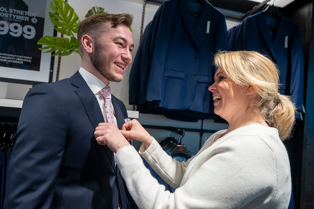 Social group, Smile, Coat, Greeting, Tie, Gesture, Happy