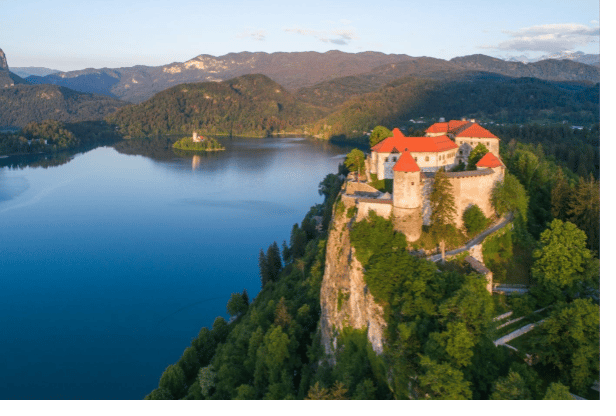 Natural landscape, Water, Sky, Mountain, Building, Azure, Plant, Lake, Highland, Tree