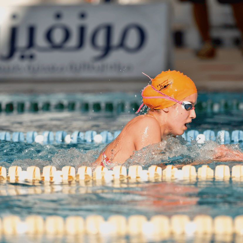 Swimming pool, Sports gear, Swim cap, Water, Swimmer, Headgear