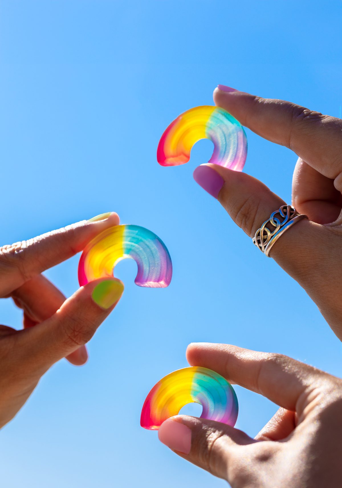 People’s hands holding up Katjes’ rainbow gummies