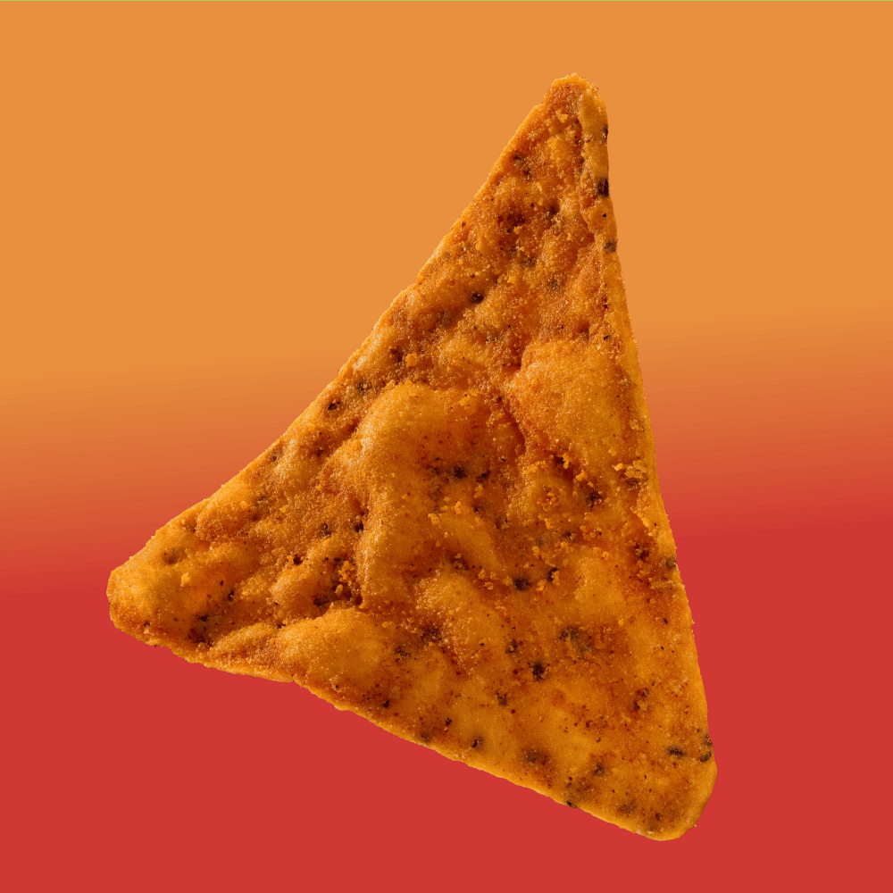 A close-up of a single triangular, seasoned tortilla chip against an orange to red gradient background.