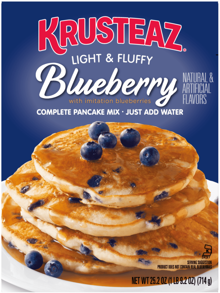Krusteaz Blueberry pancake mix box, featuring a stack of golden pancakes with blueberries and syrup.