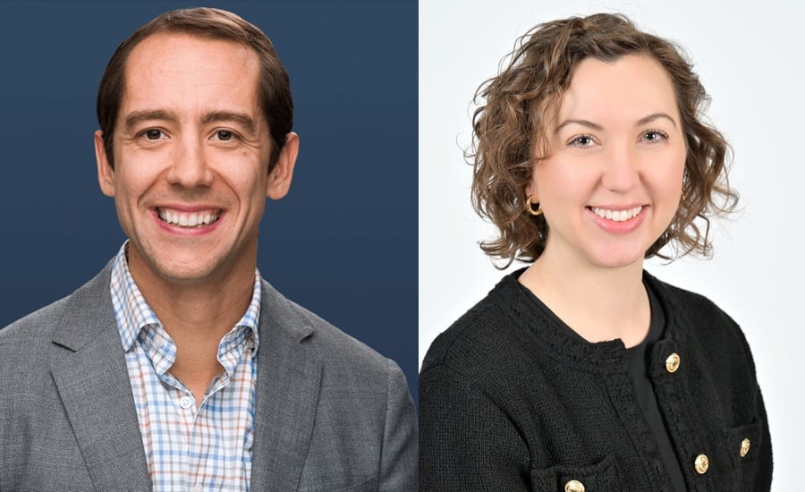 Two smiling people, a man and a woman.