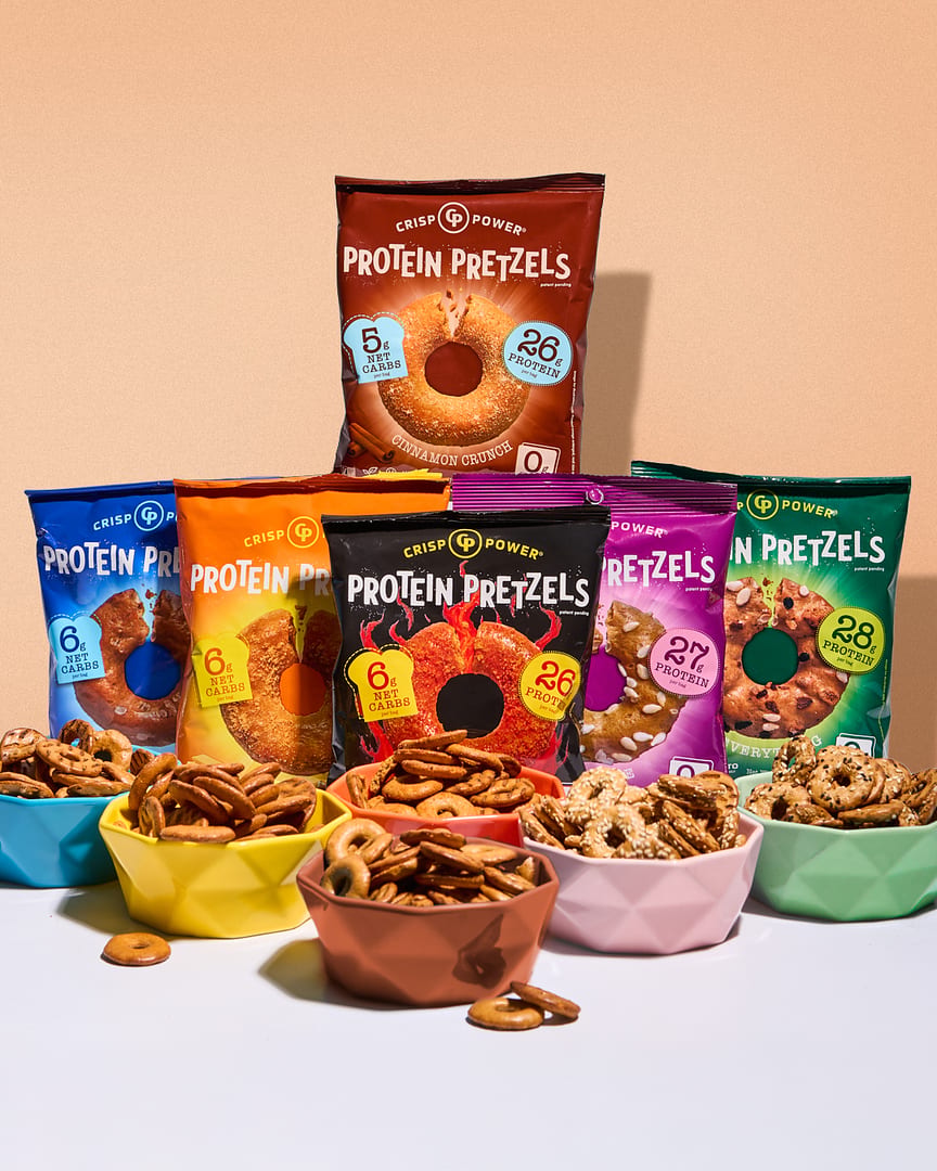 Crisp Power Protein Pretzels bags and bowls in various flavors like Cinnamon Crunch.