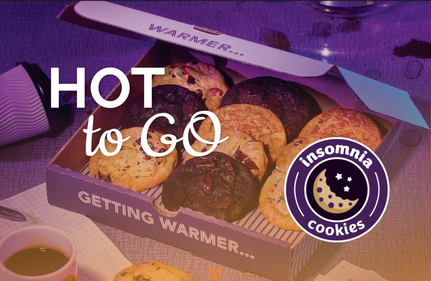 Open box of Insomnia Cookies, 'HOT to GO' text, and coffee cups.