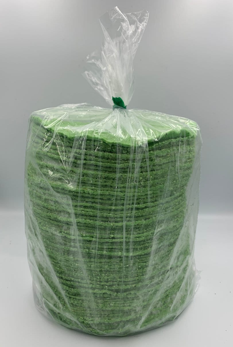Stack of green corn tortillas in clear plastic bag.
