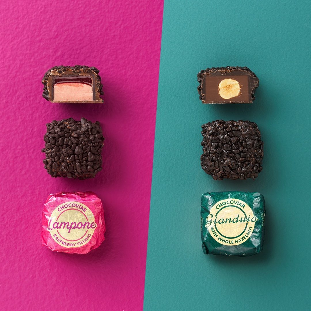 Two rows of Chocolates: raspberry (open & wrapped) on pink, hazelnut (open & wrapped) on teal.