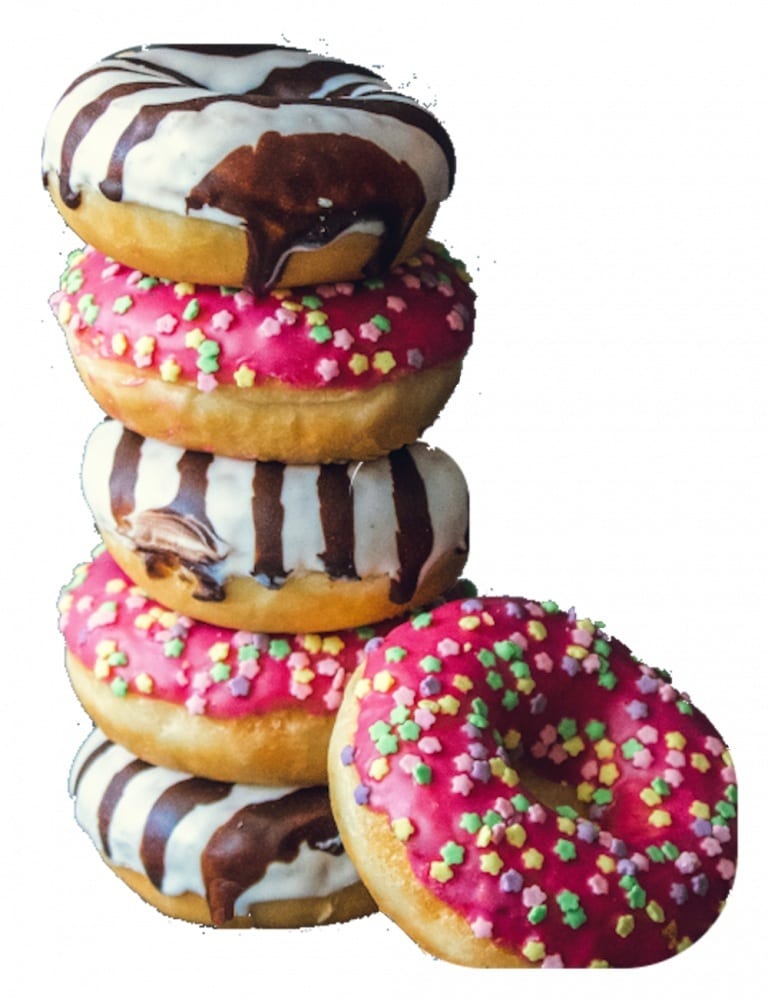 A stack of colorful donuts: pink with sprinkles, white with chocolate stripes, and one more pink with sprinkles.