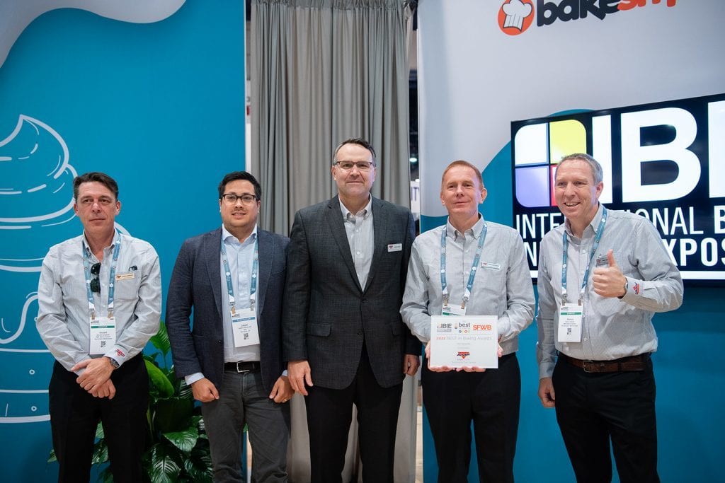 Suit trousers, Show booth, Award, Suit jacket, Smile, Group of people