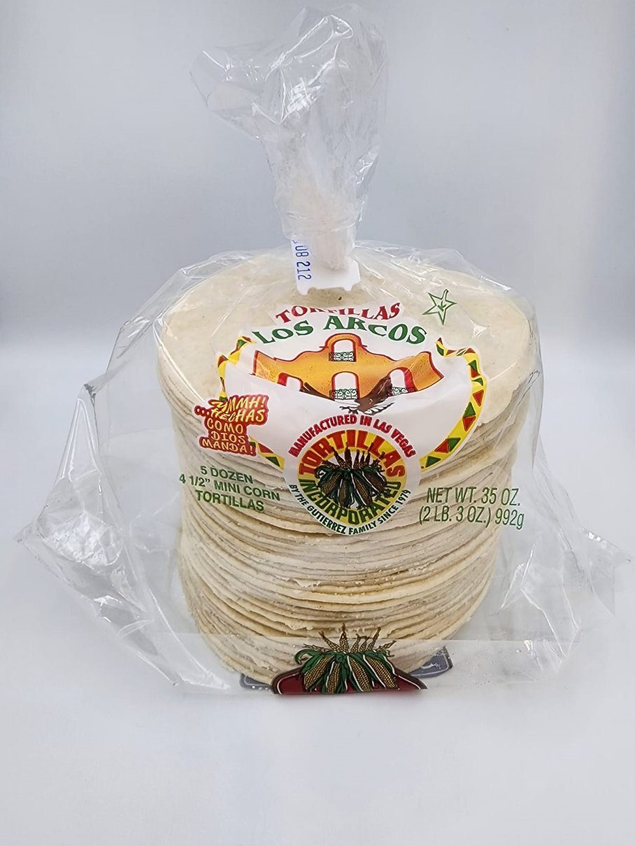 A clear plastic bag of Los Arcos mini corn tortillas, with a prominent label showing product details.