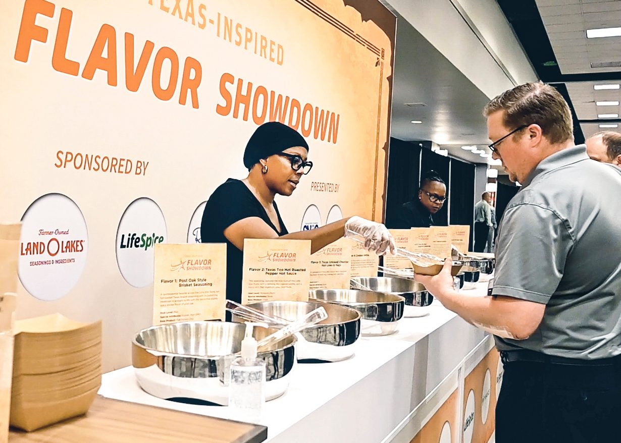 Woman serving samples at a "Texas-Inspired Flavor Showdown" event with Land O'Lakes sponsorship.