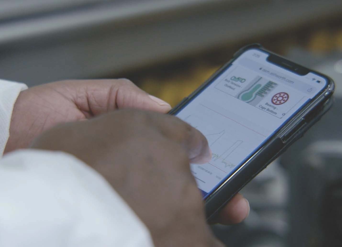 Hand working smartphone running SmartOven app