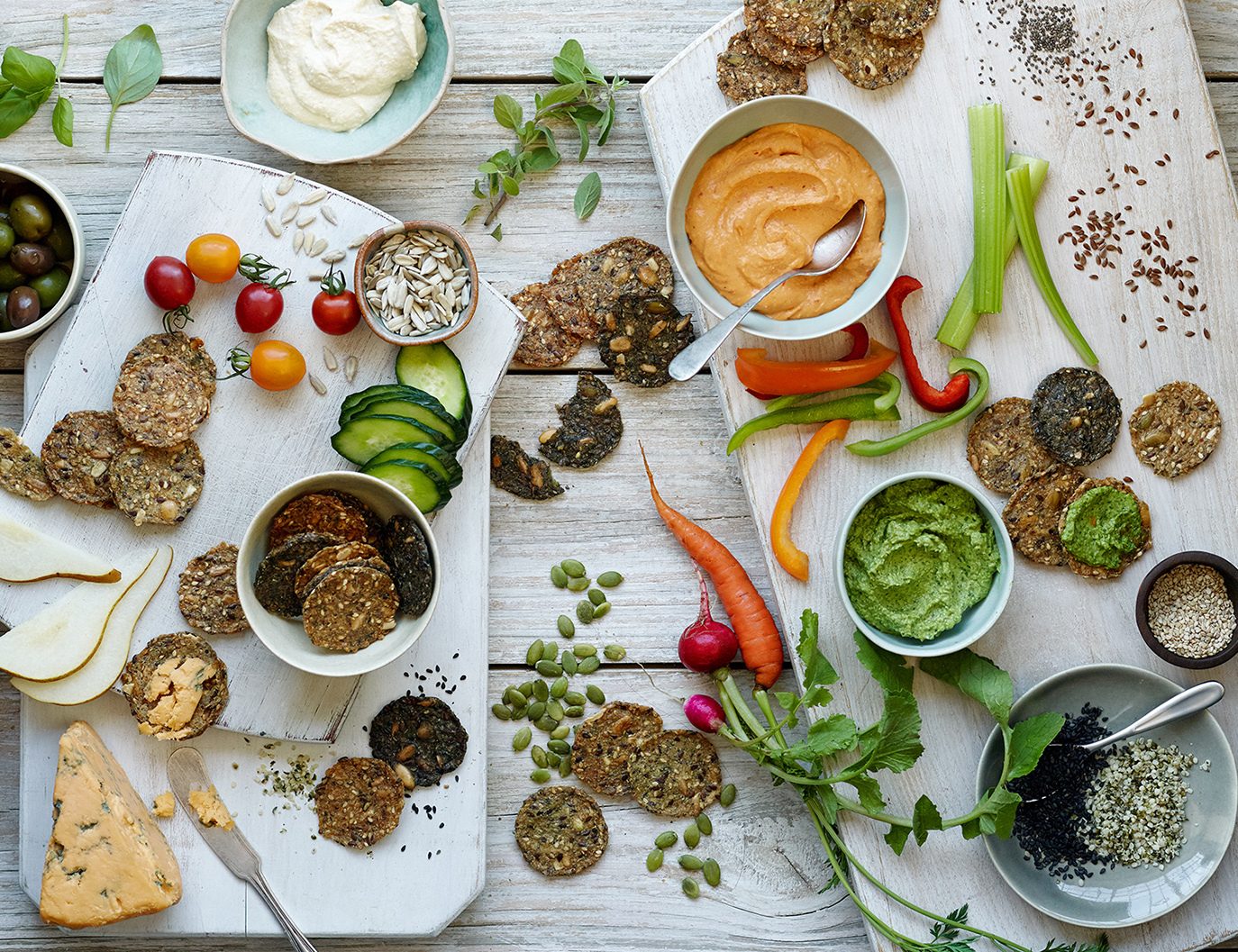 Overhead view of a charcuterie board with Mary’s Gone Crackers products plus vegetables