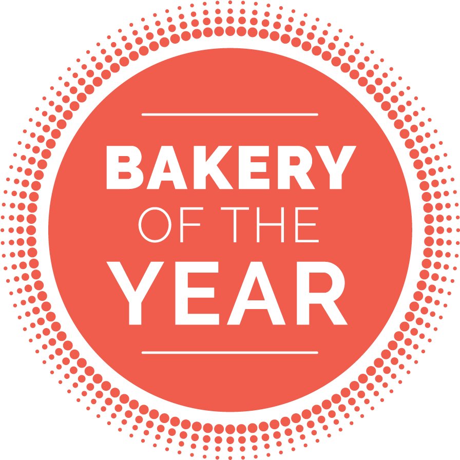 Red "BAKERY OF THE YEAR" award badge with a dotted border on a green background.