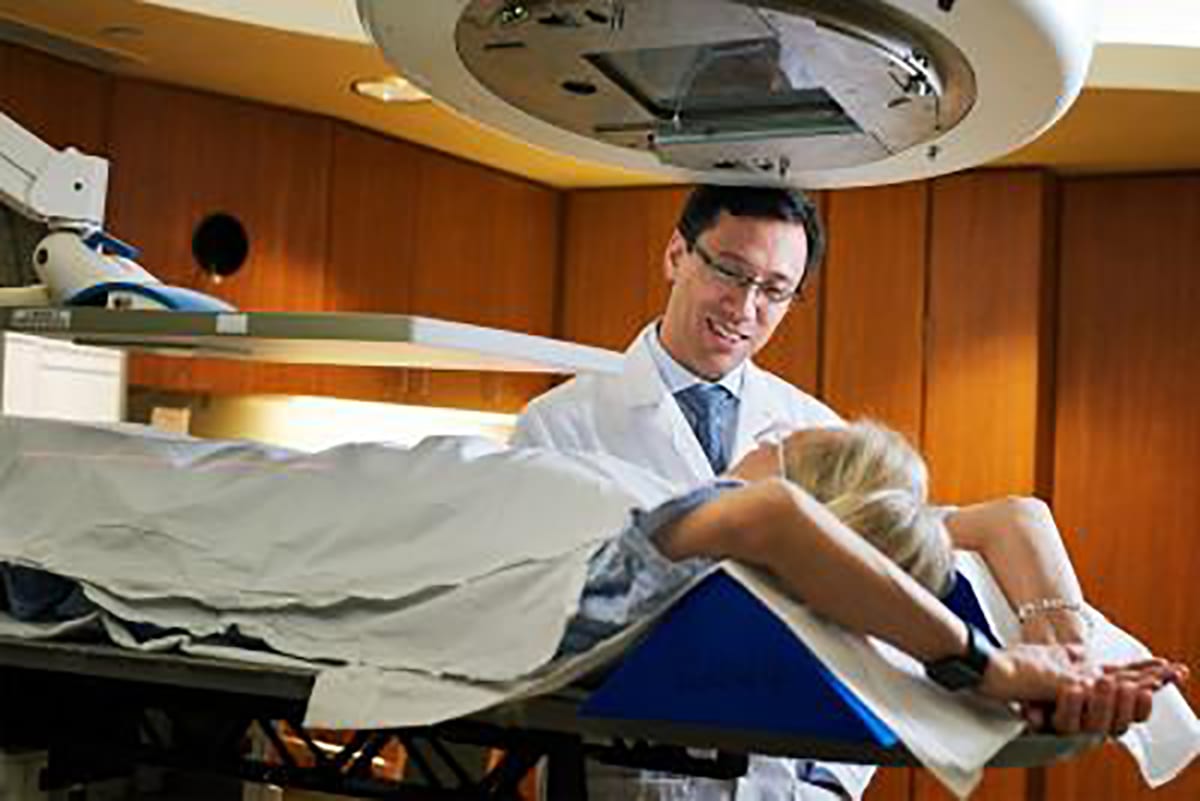 Doctor with his patient in an xray room 