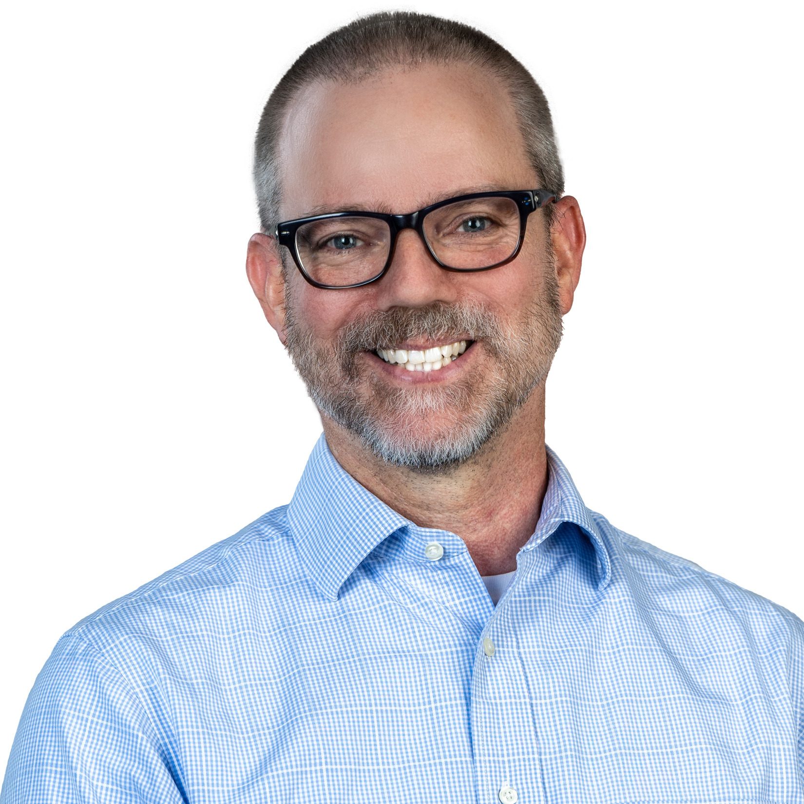 Smiling man in glasses and blue checkered shirt with gray beard on white background.