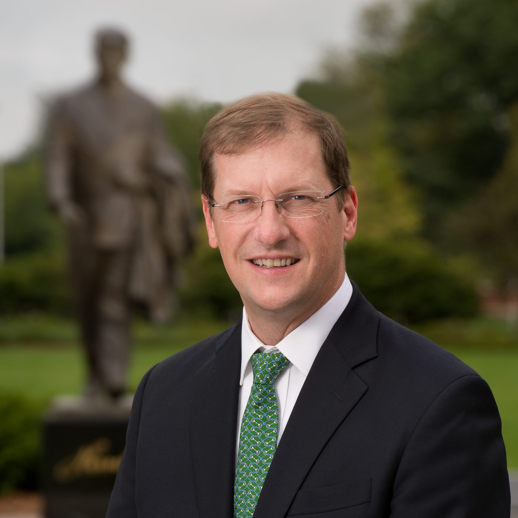 Dress shirt, Vision care, Glasses, Smile, Vertebrate, Tie, Sleeve, Mammal, Coat, Gesture