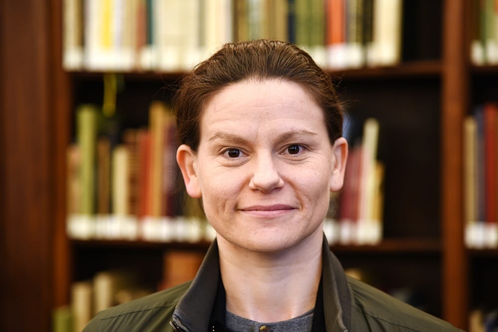 Facial expression, Forehead, Cheek, Chin, Smile, Eyebrow, Bookcase, Shelf, Happy, Collar