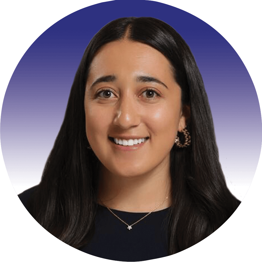 Smiling woman with long dark hair, wearing a dark top and star necklace against a blue background.