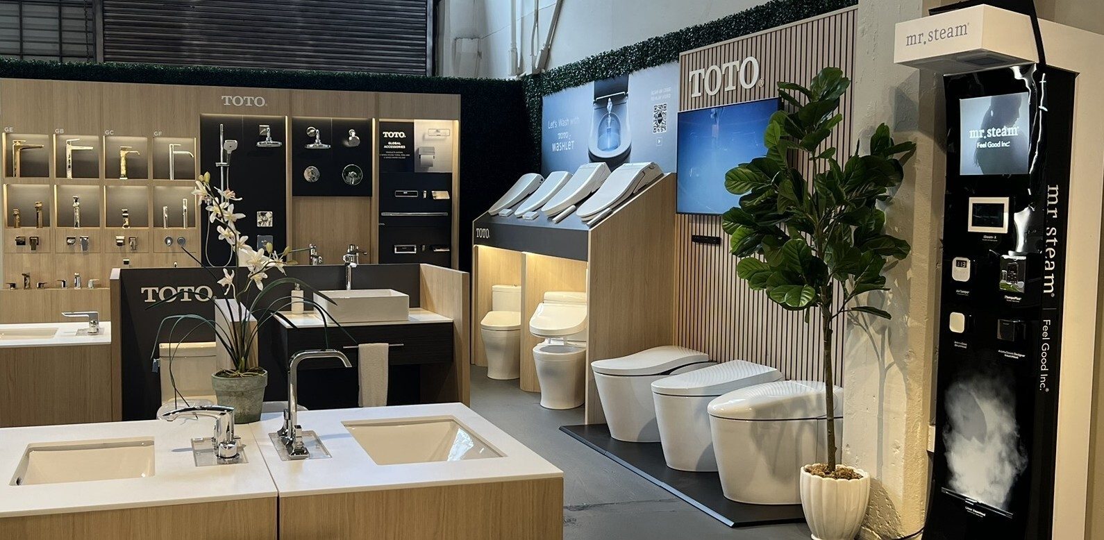 TOTO and Mr. Steam bathroom showroom displaying faucets, sinks, toilets, washlets, and steam products.