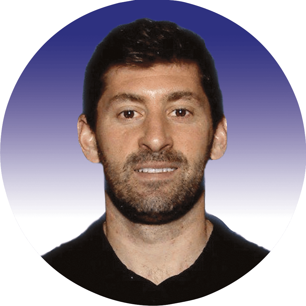 Man with dark hair and beard, smiling, in a circular profile picture.
