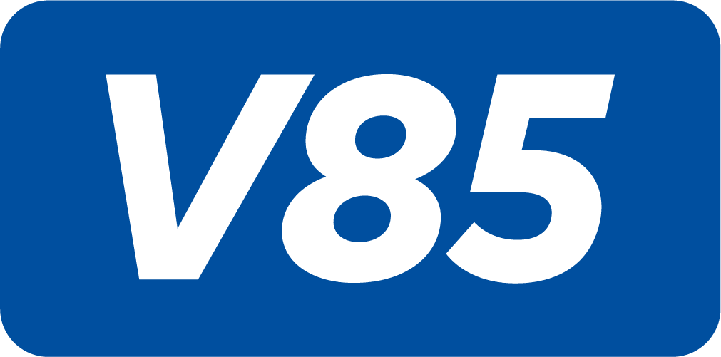 Blue rectangular sign with rounded corners displaying the white alphanumeric text "V85".