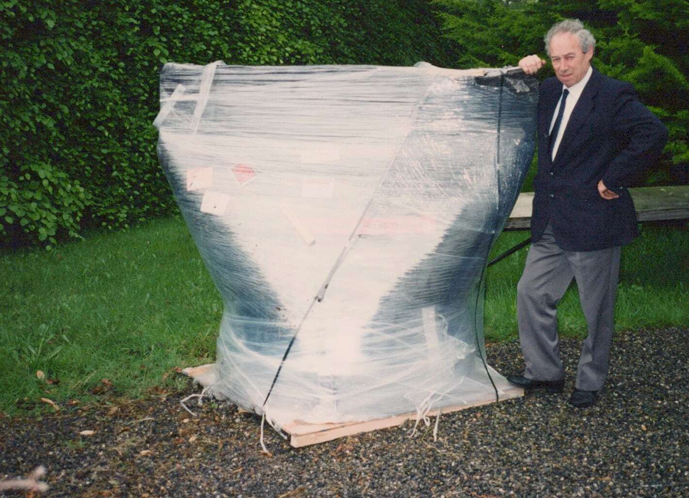 Maurice Radford beside a large duckbill valve packed for shipping, 1998