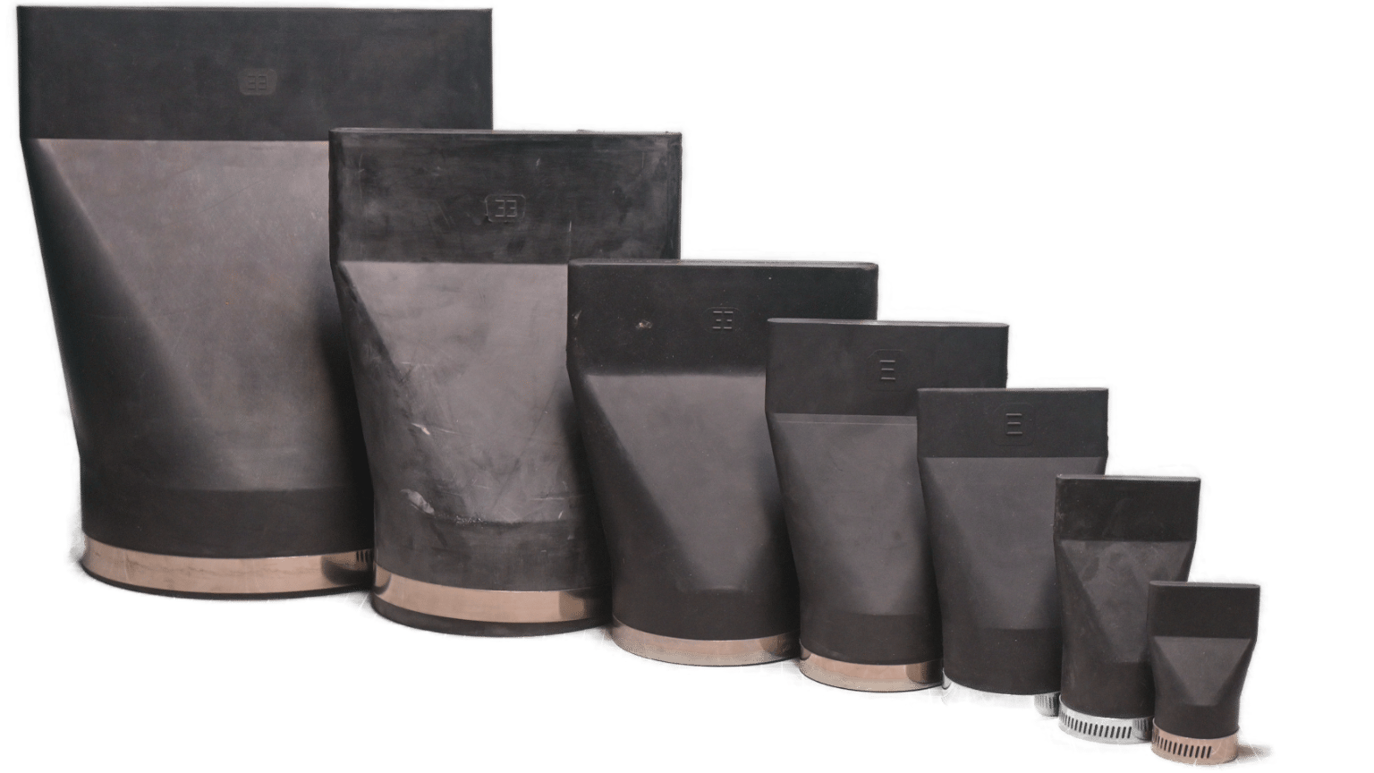 Black rubber flexible connectors/boots in various sizes, arranged diagonally.