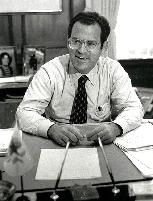 Office supplies, White-collar worker, Clothing, Glasses, Eyewear, Furniture, Table, Necktie, Desk, Smile