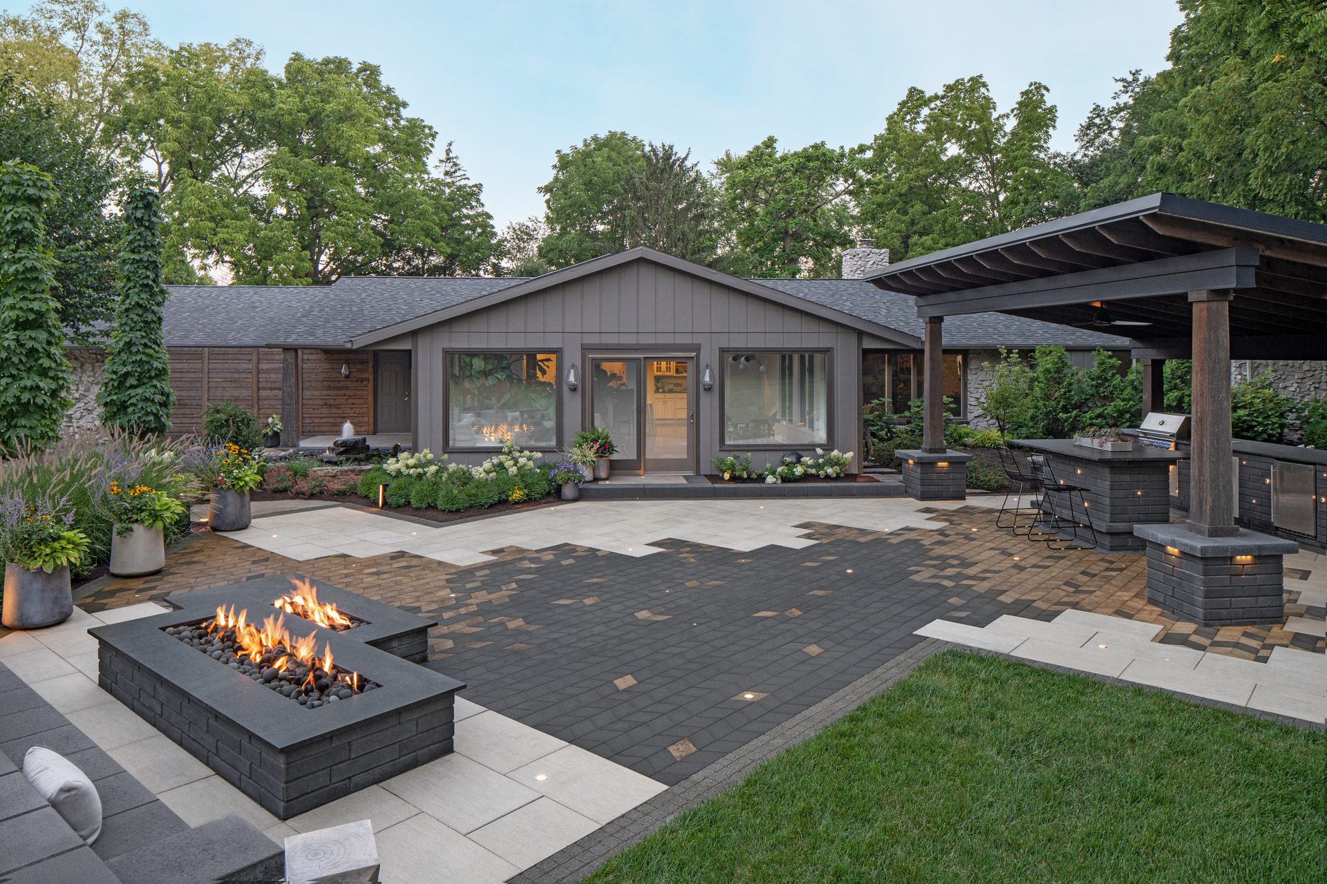 Aerial view of a backyard complete with a dining area, firepit and walkway.