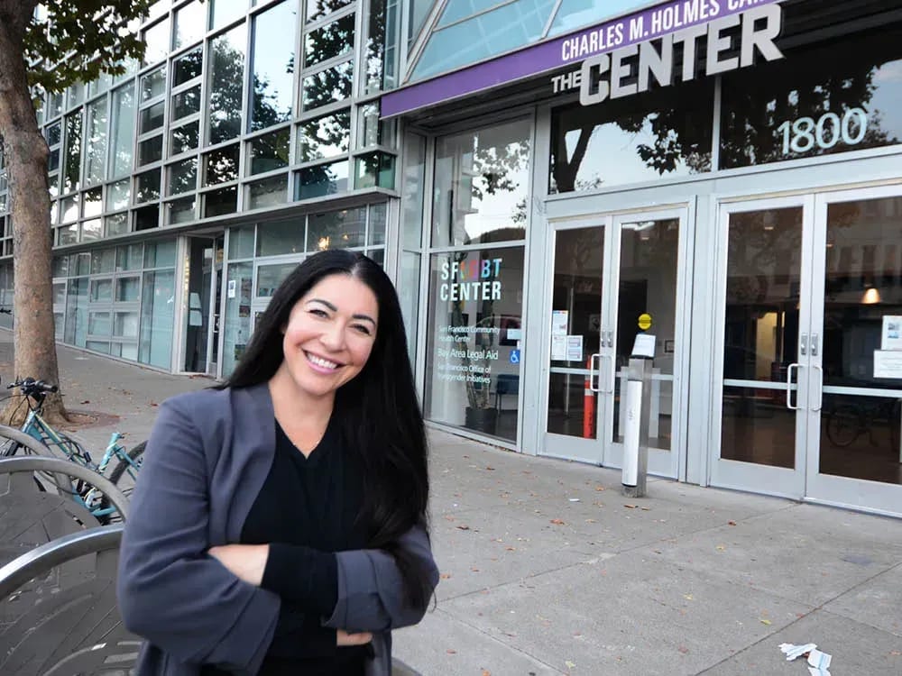 Smiling woman in front of the SF LGBT Center.