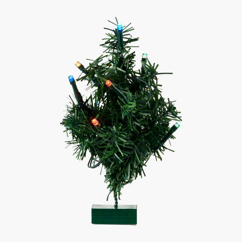 Small artificial Christmas tree with colorful LED lights and a green base.