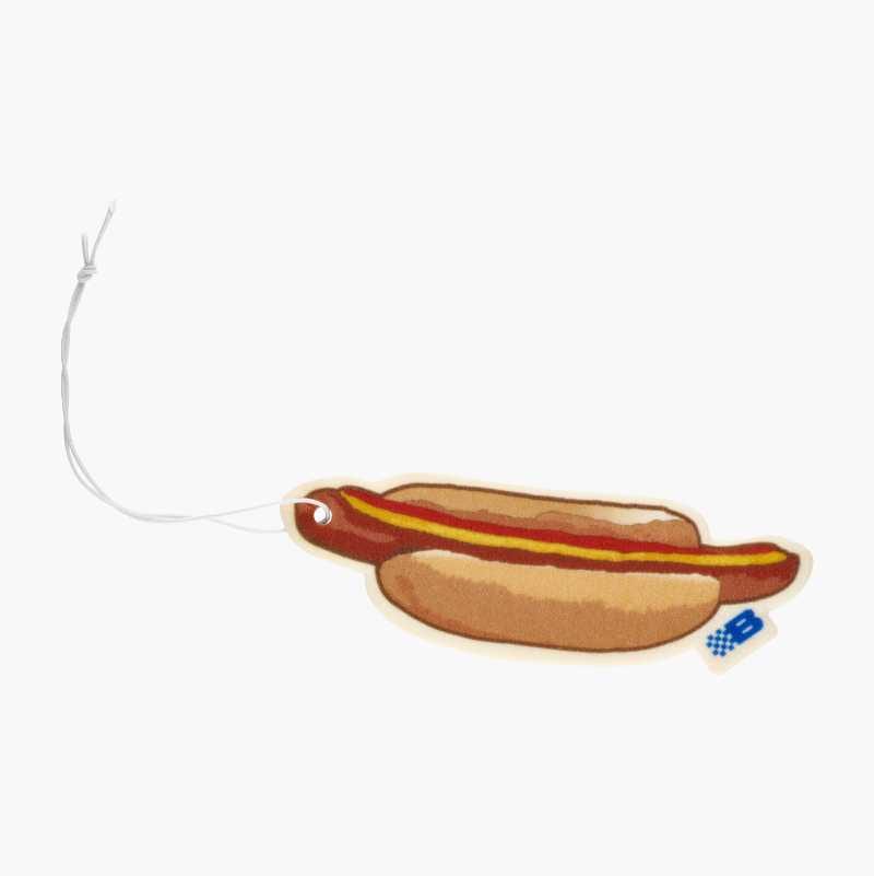 A cartoon hot dog air freshener with ketchup, mustard, and a hanging string on white.