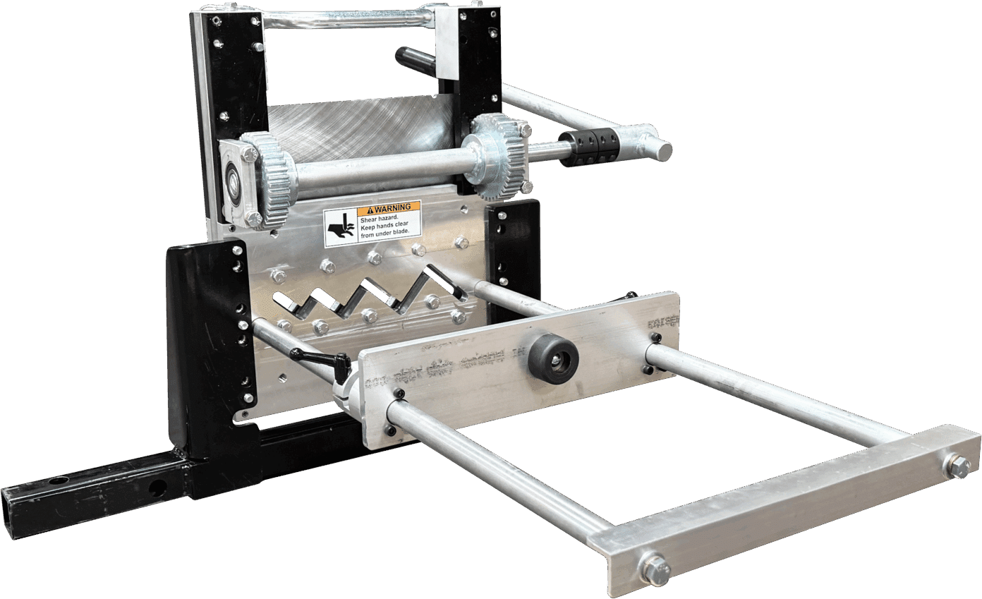 Industrial metal shear machine with zigzag blades and front guides, featuring a warning label.