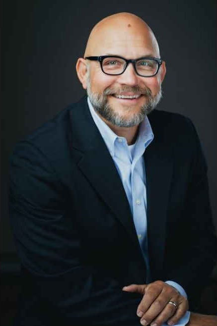 Vision care, Dress shirt, Forehead, Smile, Glasses, Chin, Sleeve, Coat, Beard, Gesture
