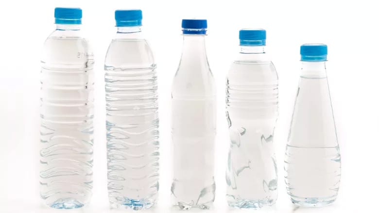 Five clear water bottles with blue caps arranged on a white background.
