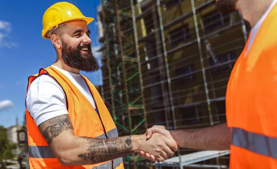 Hard hat, Construction worker, Workwear, Orange, Yellow, Beard, Engineer, Gesture, Headgear